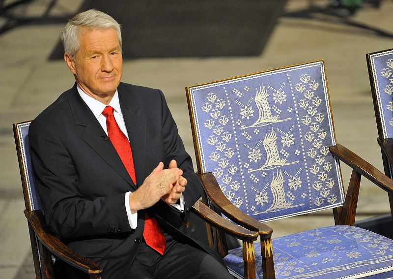 The Norwegian Nobel Committee chairman Jagland applauds next to the empty chair where Nobel Peace Prize winner Liu Xiaobo should sit during the Nobel Peace Prize ceremony in Oslo
