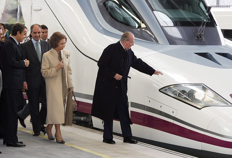 Spain's King Juan Carlos touches the AVE high speed train at the Joaquin Sorolla Station after it's inaugural journey in Valencia