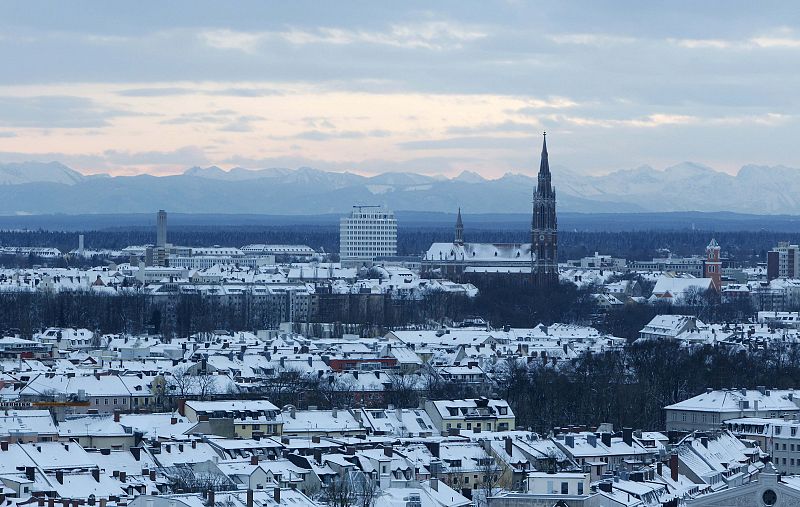 A general view shows the Alps behind the snow covered roofs of Munich