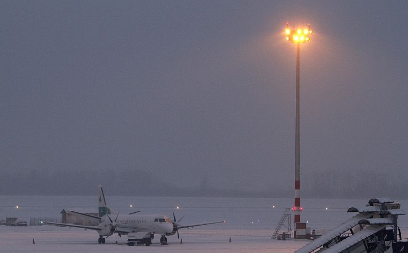 An airplane is seen at the snow-covered Budapest International Airport