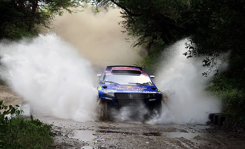 Volkswagen pilot Miller of the U.S crosses a dam during the first stage of the third South American edition of the Dakar Rally 2011 from Victoria to Cordoba