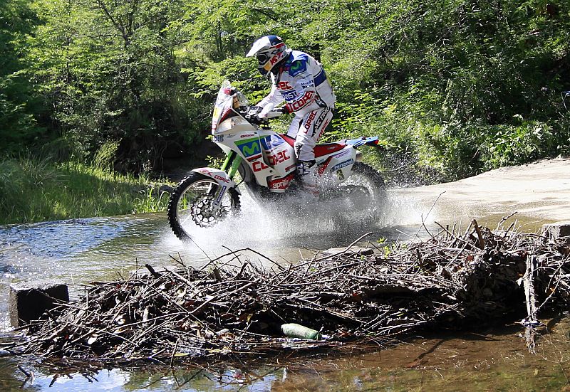 Aprillia pilot Francisco Lopez Contardo of Chile crosses a dam during the first stage of the third South American edition of the Dakar Rally 2011 from Victoria to Cordoba