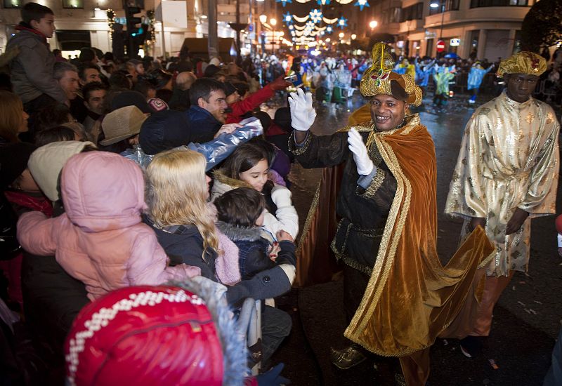 A man dressed as a "Wise Man" greets children during the annual Epiphany parade through central Burgos