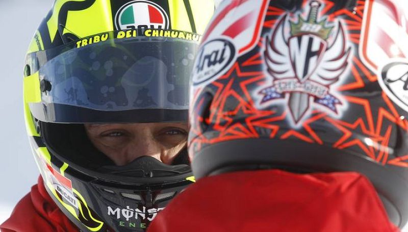 Ducati Moto GP rider Rossi speaks with  teammate Hayden in Madonna di Campiglio