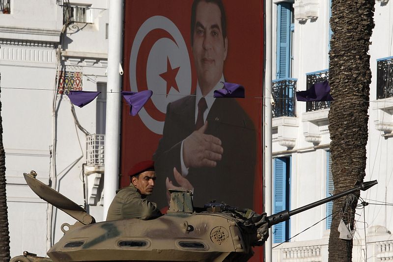 A Tunisian army soldier patrols in a tank in downtown Tunis