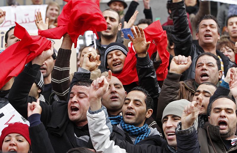 Tunisian people living in Belgium shout slogans during a protest against Tunisian President Ben Ali in Brussels