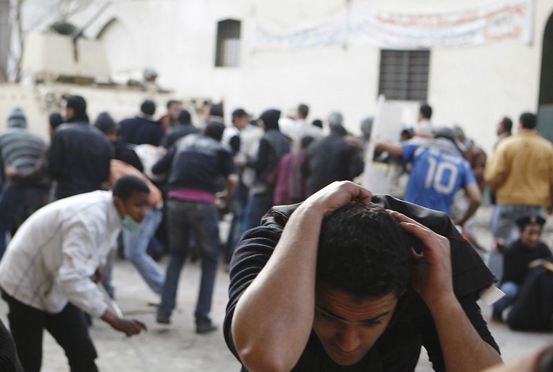 Egyptian anti-government protesters clash with riot police at Tahrir Square in downtown Cairo