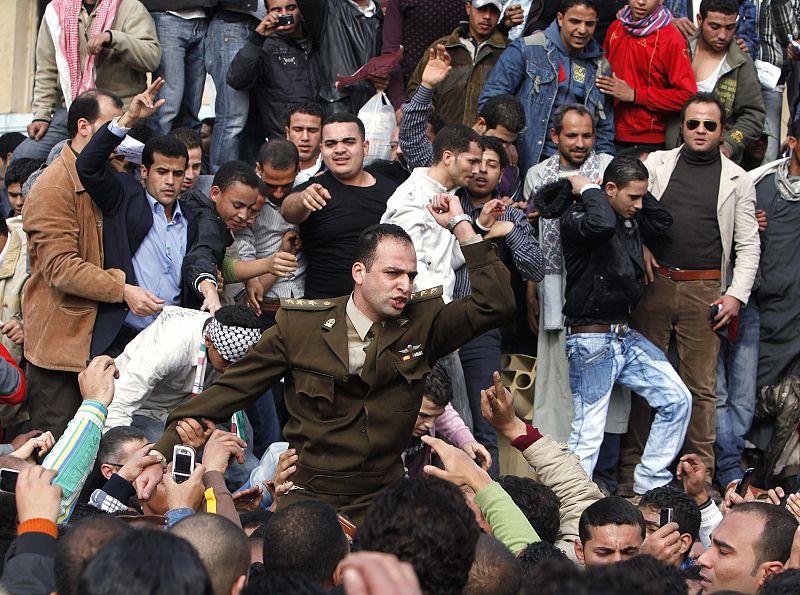 Protesters welcome a soldier during a demonstration in Cairo