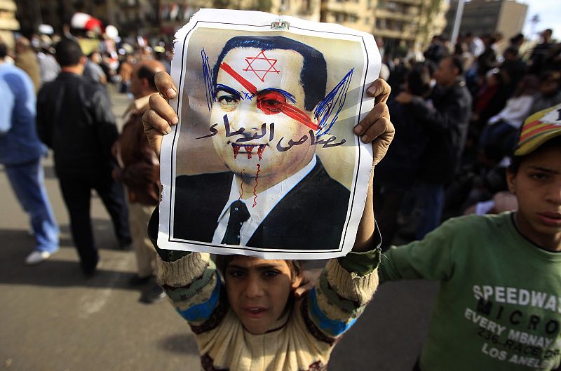 A boy holds a poster of Egypt's President Hosni Mubarak, in Cairo