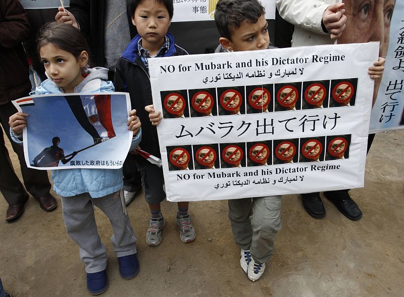 Egyptian child residents in Japan hold banners during a rally in Tokyo
