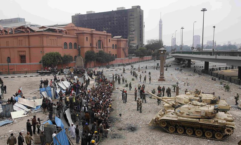 Egyptian army tanks move towards opposition supporters near Tahrir Square in Cairo