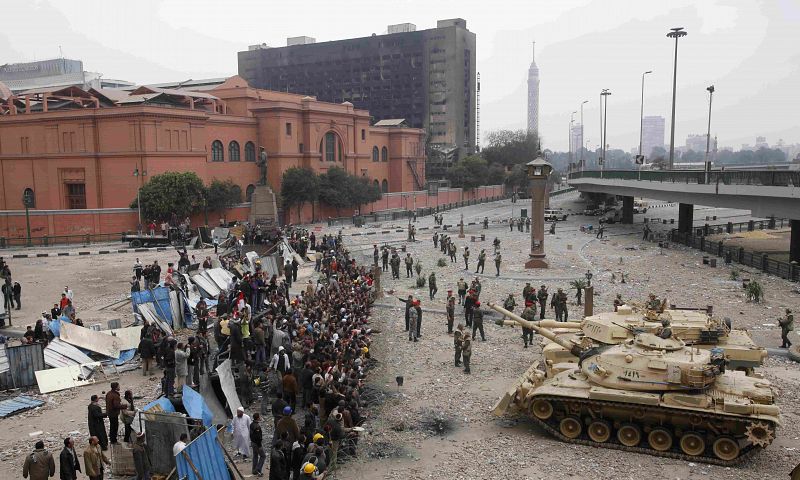 Egyptian army tanks move towards opposition supporters near Tahrir Square in Cairo
