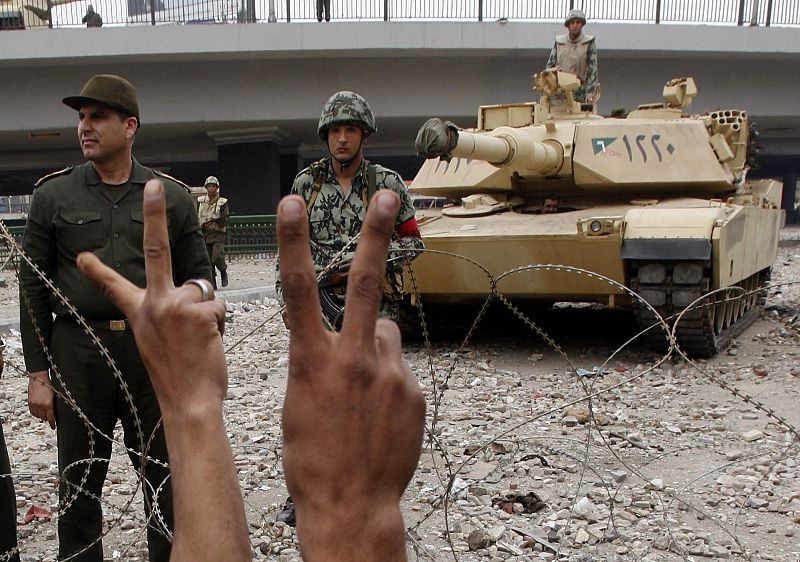 Opposition supporters flash victory signs near Tahrir Square in Cairo