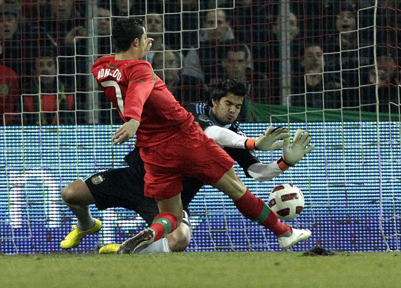 Portugal's Ronaldo scores a goal against Argentina's goalkeeper Romero during their international friendly soccer match at the Stade de Geneve in Geneva