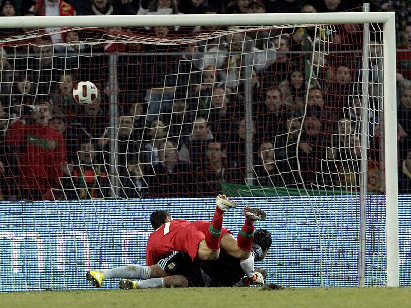 Portugal's Ronaldo scores a goal against Argentina's goalkeeper Romero during their international friendly soccer match at the Stade de Geneve in Geneva