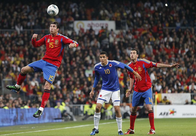 Spain's Ramos heads the ball next Colombia's Moreno and Spain's Busquets during their international friendly soccer match in Madrid