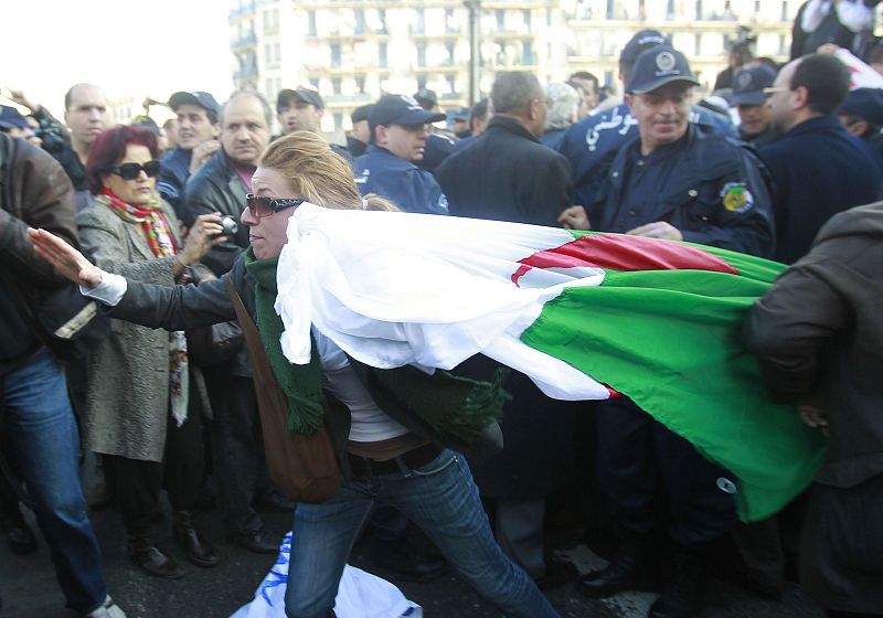 A woman carries an Algerian flag during a demonstration in Algiers