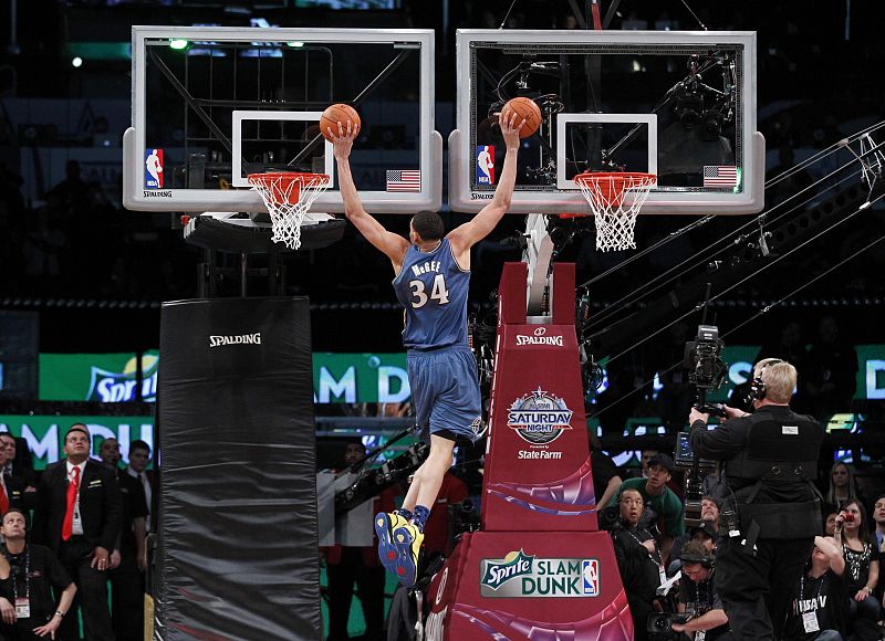 Wizards' McGee dunks two balls during the slam dunk contest at the NBA basketball All-Star weekend in Los Angeles