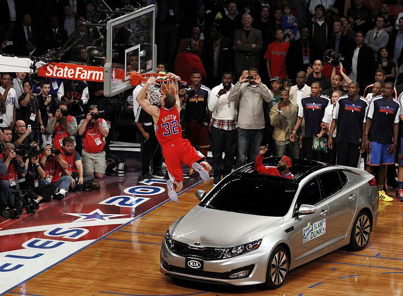 Clippers' Blake Griffin jumps over a car while competing in the slam dunk contest during the NBA All-Star weekend in Los Angeles