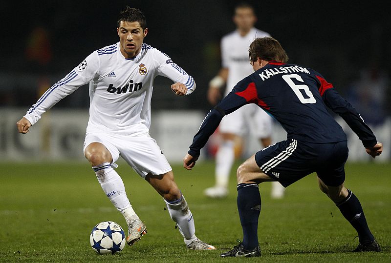 Olympique Lyon's Kallstrom challenges Real Madrid's Ronaldo during their Champions League soccer match at the Gerland stadium in Lyon