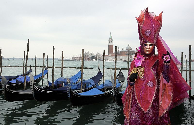 A masked reveller poses in Saint Mark's Square during the Venetian Carnival in Venice