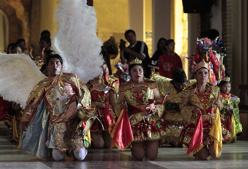 Members of the "Diablada Autentica" attend a catholic mass during the Carnival parade