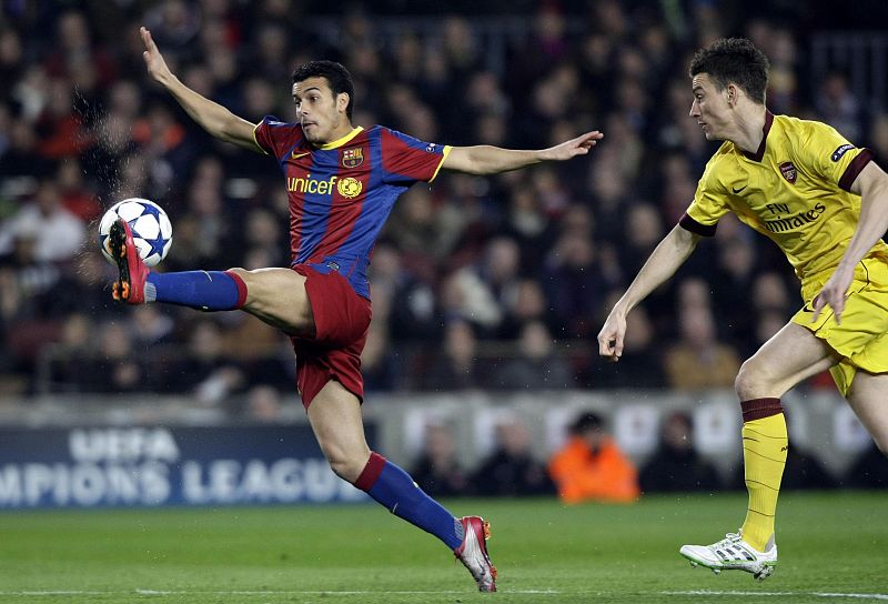 Barcelona's Pedro controls the ball challenged by Arsenal's Koscielny during their Champions League soccer match in Barcelona