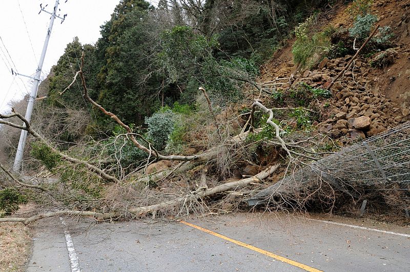 A road is blocked by a landslide near Iwaki City in northeastern Japan