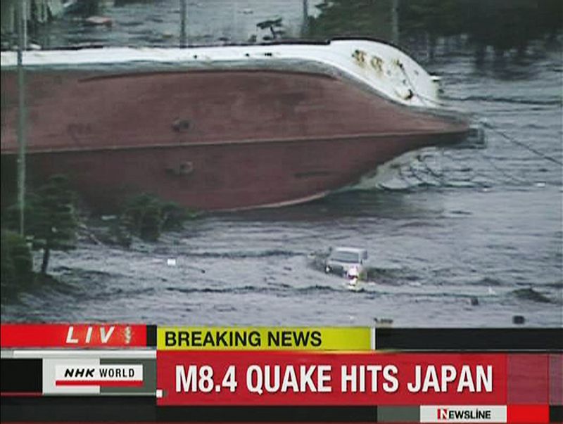 Frame grab of an overturned boat following a tsunami in Hachinohe
