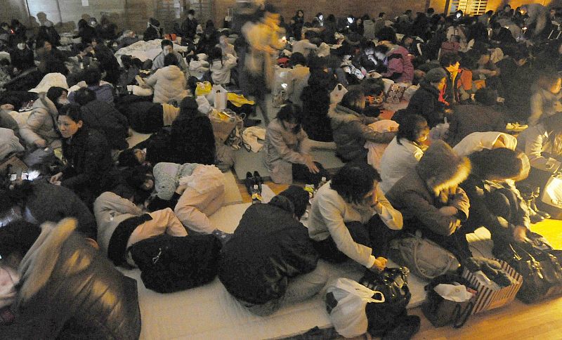 Evacuees take shelter at an evacuation centre after an earthquake and tsunami in Sendai, northeastern Japan