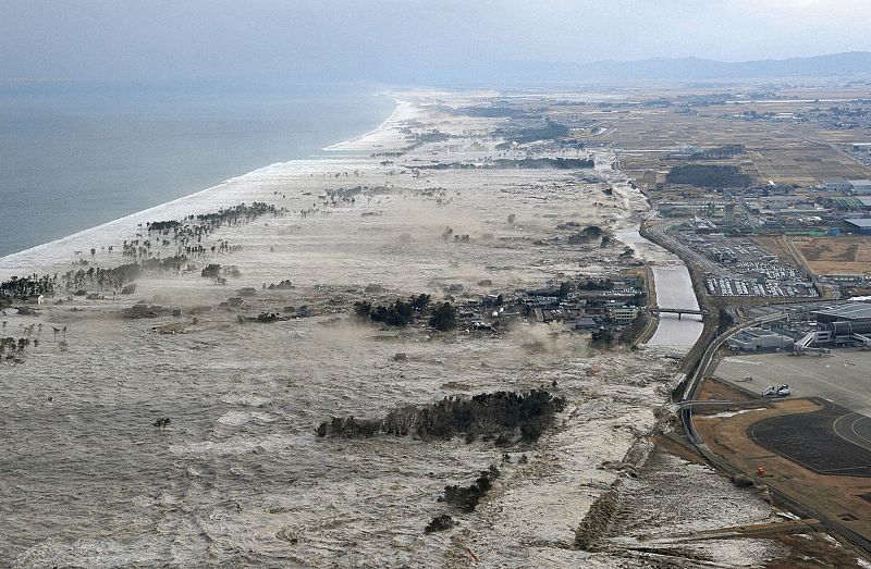A massive tsunami hits the coastal areas of Iwanuma, Miyagi Prefecture, northeastern Japan