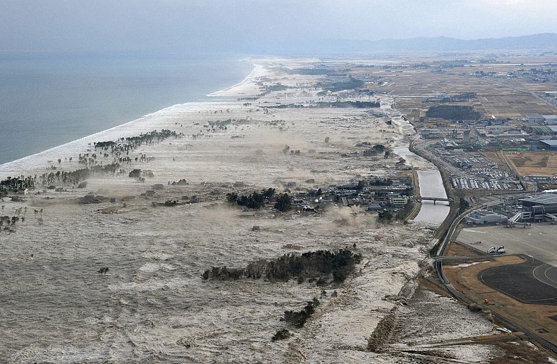 A massive tsunami hits the coastal areas of Iwanuma, Miyagi Prefecture, northeastern Japan