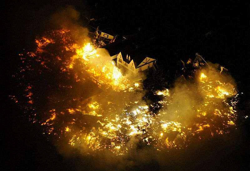 Buildings burn after an earthquake near Sendai Airport, northeastern Japan