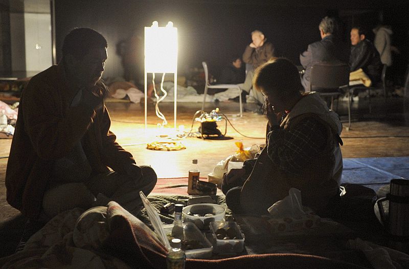 A couple eats a meal at an evacuation center in Ofunato, Iwate Prefecture in northeastern Japan