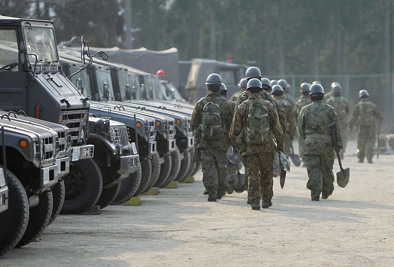 Soldiers from Japan's Self Defence Force arrive at the scene of devastation in Rikuzentakata, northern Japan