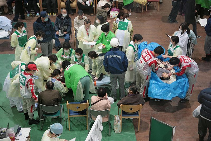 Survivors of an 8.9-magnitude earthquake and tsunami receive treatment at the Ishinomaki Red Cross hospital in Miyagi prefecture
