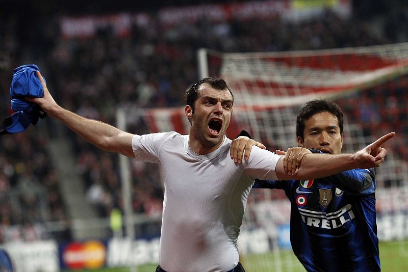 Pandev and Nagatomo of Inter Milan celebrate during the second leg round of sixteen Champions League soccer match against Bayern Munich in Munich