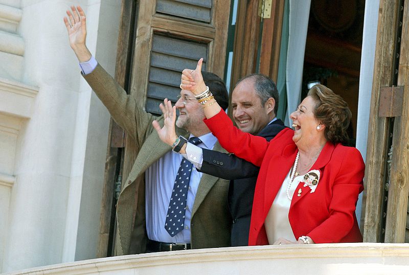 El presidente del Partido Popular, Mariano Rajoy, saluda junto al president de la Generalitat, Francisco Camps y la alcaldesa de Valencia, Rita Barberá, al público que llena la plaza minutos antes del disparo de la mascletá.