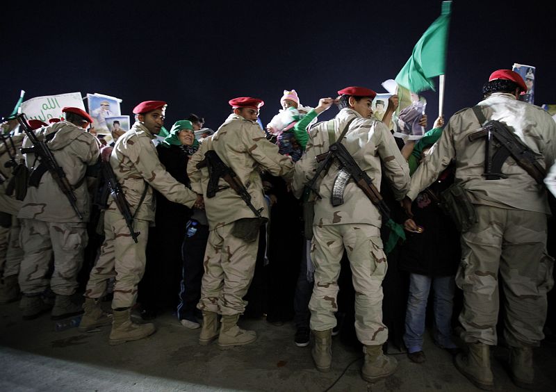 Libyan army soldiers loyal to Libya's leader Muammar Gaddafi guard the protest at Bab Al-Aziziyah in Tripoli