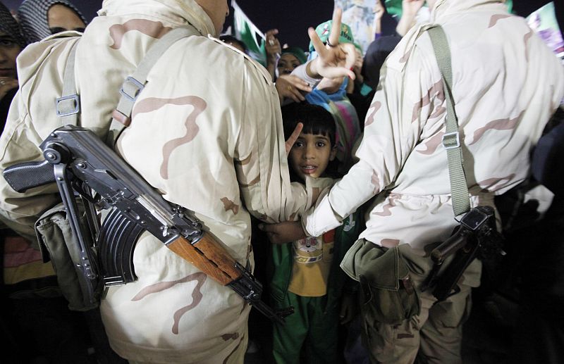 Soldiers block a supporter loyal to Libya's leader Muammar Gaddafi at Bab Al-Aziziyah in Tripoli M