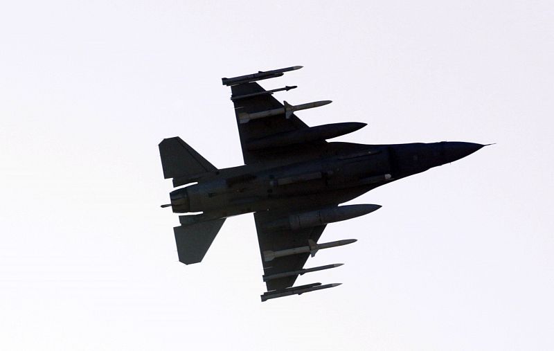 A F-16 jet fighter flies over a NATO airbase in Aviano