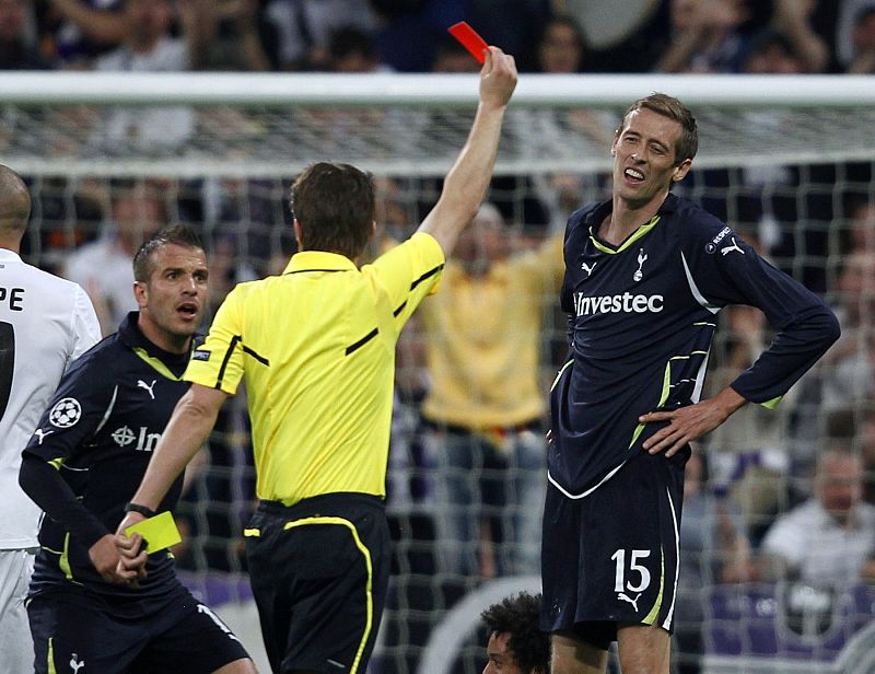 Tottenham Hotspur's Crouch receives a red card from referee Brych of Germany during the first leg of their Champions League quarter-final soccer match against Real Madrid at Santiago Bernabeu stadium in Madrid