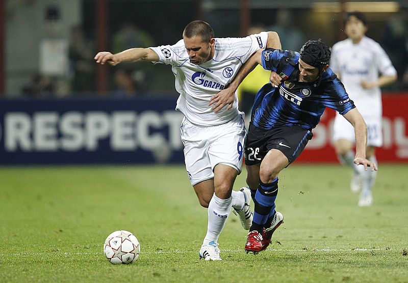Inter Milan's Chivu challenges Schalke 04's Edu during their first leg of the Champions League quarter-final soccer match in Milan