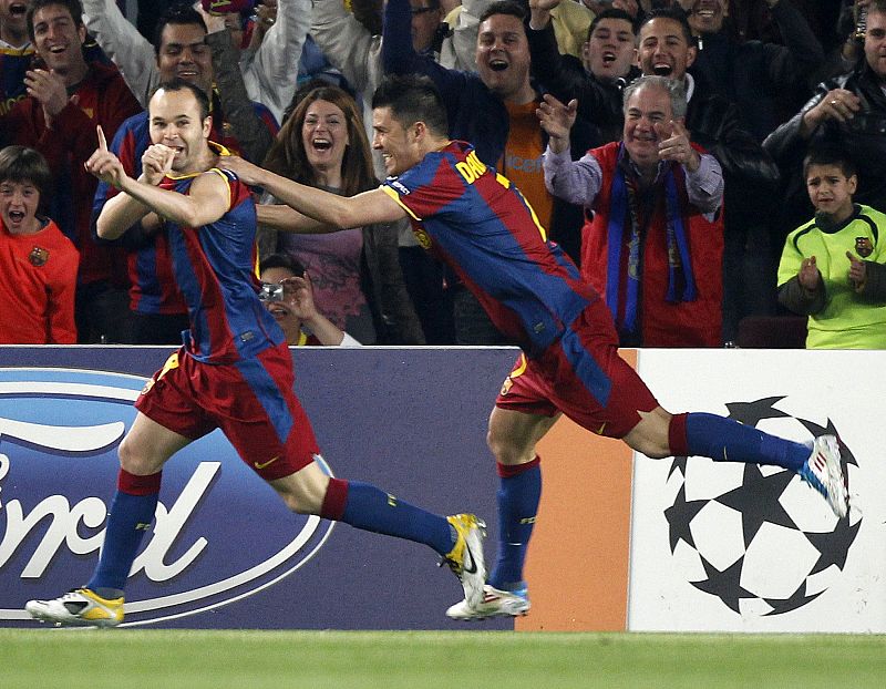 Barcelona's Iniesta celebrates with team-mate Villa after scoring against Shakhtar Donetsk during the first leg of their Champions League quarter-final soccer match in Barcelona