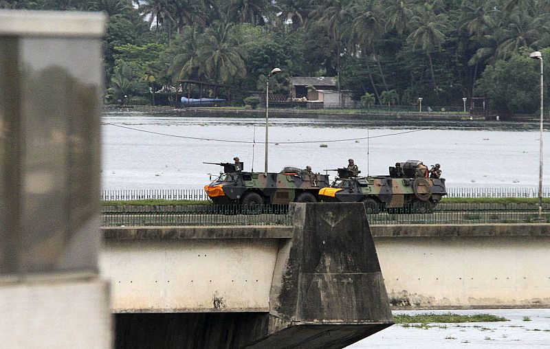 French armoured personnel carriers cross General de Gaulle bridge in Abidjan