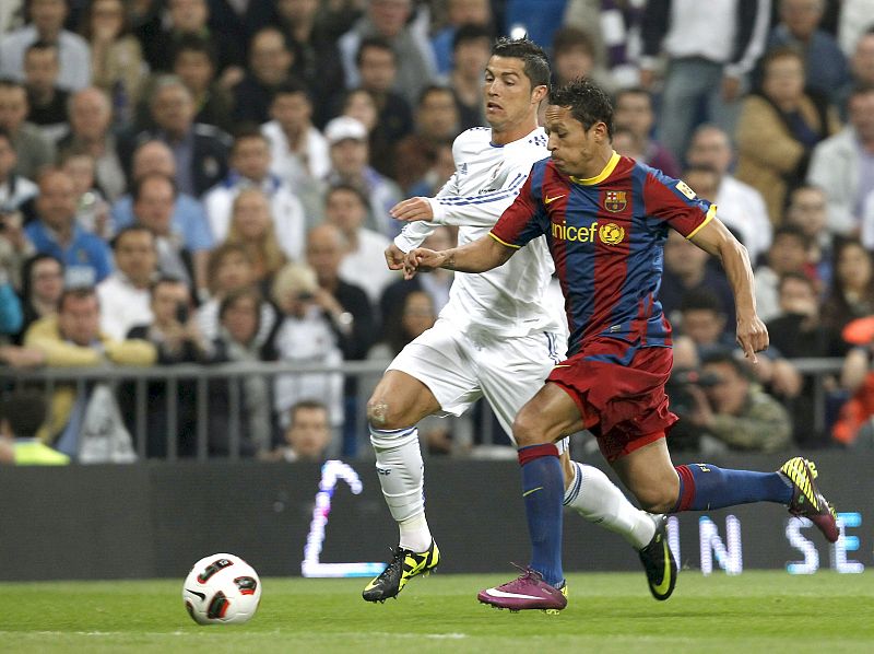 Cristiano Ronaldo pugna por el balón con el defensa brasileño del FC Barcelona Adriano Correia.