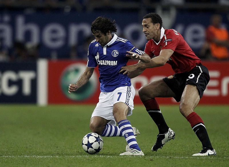 Gonzalez of Schalke 04 is tackled by Manchester United's Ferdinand during their Champions League soccer match in Gelsenkirchen