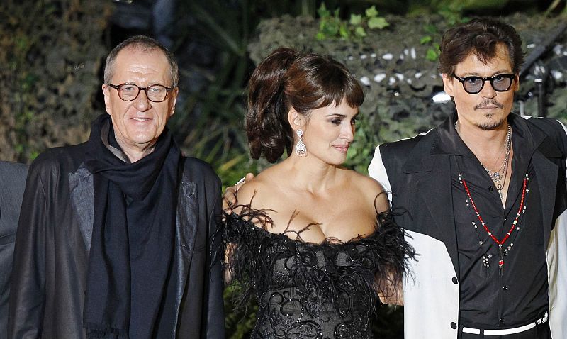 Cast members Depp, Cruz and Rush stand on stage before the premiere of "Pirates of the Caribbean: On Stranger Tides" at Disneyland in Anaheim