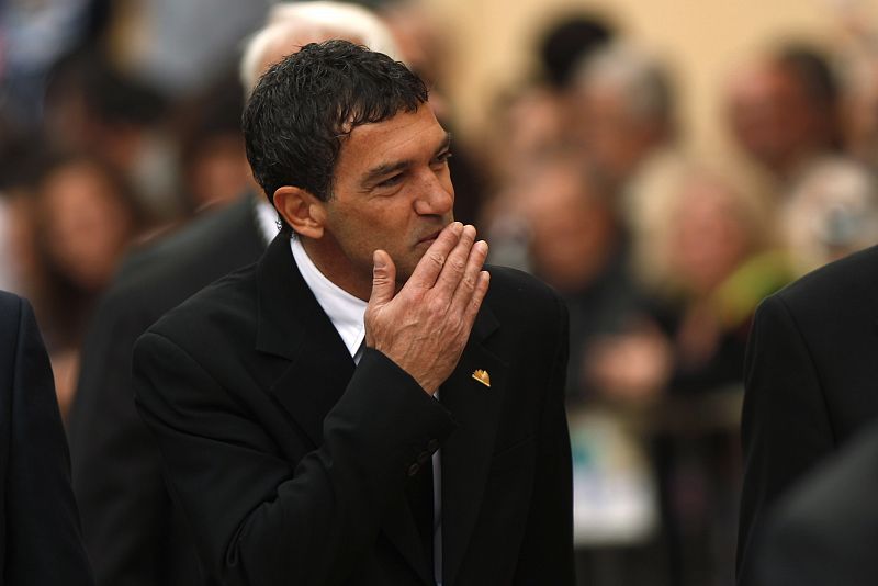 Spanish actor and director Banderas blows kiss to crowd as he arrives to watch Spanish legionnaires carry statue of Christ of Mena during Holy Week in Malaga