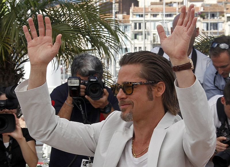 Actor Pitt gestures during a photocall for the film The Tree of Life in competition at the 64th Cannes Film Festival